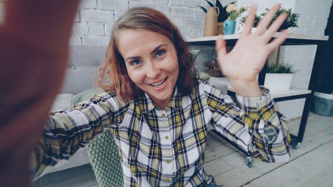 Belgian businesswoman taking a professional networking video call at her desk